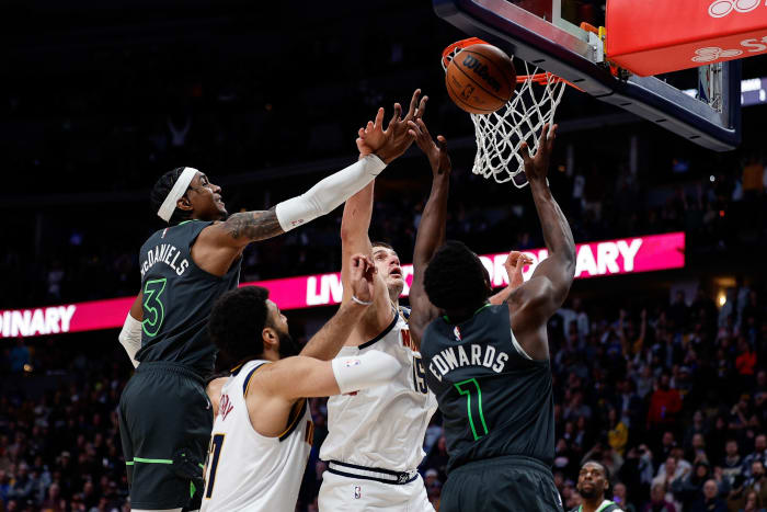 Jan 18, 2023; Denver, Colorado, USA; Denver Nuggets center Nikola Jokic (15) battles for a rebound with Minnesota Timberwolves forward Jaden McDaniels (3) and guard Anthony Edwards (1) as guard Jamal Murray (27) defends in the fourth quarter at Ball Arena.